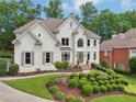 Charming two-story home with a lush front yard and manicured landscaping at 1225 Elk Ridge Cv, Alpharetta, GA 30005