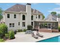 Expansive backyard featuring a large pool, covered patio, and ample seating at 1225 Elk Ridge Cv, Alpharetta, GA 30005