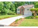 Traditional two-story home with brick accents, a well-manicured lawn, and a long driveway at 190 Crestworth Ct, Powder Springs, GA 30127