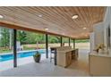 Inviting covered outdoor area with a bar, view of the pool, and lush greenery at 2648 Varner Ne Dr, Atlanta, GA 30345