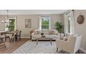 Inviting living room space, featuring a comfortable couch, stylish decor, and natural lighting at 306 Birch St, Canton, GA 30114