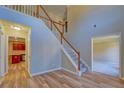 Spacious foyer with wood floors, stairway with white railings, and views to the kitchen at 3071 Springfair Trott, Lithonia, GA 30038