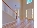 Bright entryway featuring wood floors, soaring ceilings, and a staircase with white railings at 3071 Springfair Trott, Lithonia, GA 30038