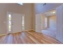 Open foyer with wood floors, a double-door entry, and a view into the adjacent room at 3071 Springfair Trott, Lithonia, GA 30038
