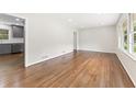 Bright, empty living room featuring gleaming hardwood floors and large windows at 3918 Oberlin Ct, Tucker, GA 30084