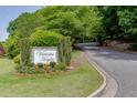 Entrance to Victoria Heights community with sign surrounded by trees, flowers, and landscaping at 4106 Santa Fe Pkwy, Atlanta, GA 30350