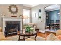Cozy living room featuring a fireplace, hardwood floors, and views of the dining area at 2639 Acorn Ne Ave, Atlanta, GA 30305