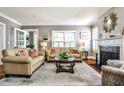 Bright living room with hardwood floors, elegant fireplace, neutral walls, and comfortable seating arrangement at 2639 Acorn Ne Ave, Atlanta, GA 30305
