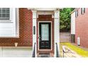 Close-up of a home's entryway, featuring a dark door and traditional brick facade at 5439 Alanis Se Pl # 17, Mableton, GA 30126