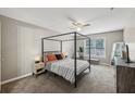 Spacious bedroom with a four-poster bed, ceiling fan, and ample natural light at 7077 Biltmore Trce, Lithonia, GA 30058