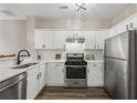Modern kitchen with stainless steel appliances, white cabinets, and stylish backsplash at 7077 Biltmore Trce, Lithonia, GA 30058