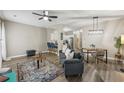 Inviting living space with modern decor, a ceiling fan, stylish rug, and open floor plan at 7077 Biltmore Trce, Lithonia, GA 30058