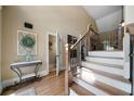 Inviting foyer with hardwood floors, staircase with iron railing, and natural light at 7251 Bluewater Ln, Douglasville, GA 30135