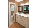Bright bathroom with a double vanity, marble countertop, and a separate toilet and shower area at 295 Lakemont Dr, Roswell, GA 30075