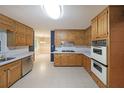 Traditional eat-in kitchen with stainless steel appliances, double oven, and ample cabinet space at 295 Lakemont Dr, Roswell, GA 30075