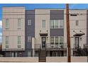 The modern townhome features a quaint porch, a black iron gate, mixed siding, and ample light at 687 Banton Nw Dr, Atlanta, GA 30318