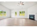 Bright living room with hardwood floors, fireplace, and natural light at 1411 Stephens View Dr, Loganville, GA 30052