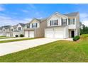Exterior view of homes showing well-maintained lawns, driveways, and attached garages at 7495 Garnet Dr, Jonesboro, GA 30236