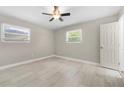 Bright bedroom with two large windows, ceiling fan, and luxury vinyl plank flooring at 2159 Fairburn Sw Rd, Atlanta, GA 30331