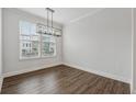 Dining room with neutral walls, contemporary lighting, and a large window at 2631 Creekside Nw Dr, Atlanta, GA 30318