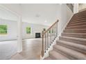 Bright living room with fireplace, hardwood floors, and staircase at 3633 Squires Park Ln, Loganville, GA 30052