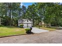 Two-story home featuring a two-car garage and a well-maintained lawn with mature trees at 5383 Biffle Way, Stone Mountain, GA 30088