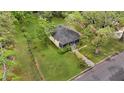 Aerial shot showcasing a well-kept lawn, a yellow home, and large trees surrounding the property at 204 Morris St, Palmetto, GA 30268