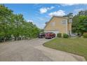 Spacious driveway provides ample parking leading to a two car garage, surrounded by lush landscaping at 2530 River Run Dr, Dacula, GA 30019