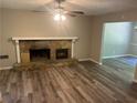 Cozy living room with a stone fireplace and modern floors at 6743 Timbers East Dr, Lithonia, GA 30058