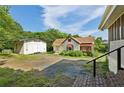 View of the home's backyard, featuring a detached garage and ample parking space at 850 Fourth St, Stone Mountain, GA 30083