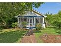 Inviting home with a cozy screened porch and a well-maintained yard, showcasing its charming curb appeal at 850 Fourth St, Stone Mountain, GA 30083