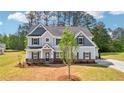 Beautiful two-story home with manicured landscaping and a welcoming front entrance at 1452 Stephens View Dr, Loganville, GA 30052