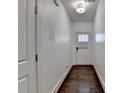 Inviting hallway with hardwood floors and fresh, bright white walls with access to rooms at 2132 Arnage Dr, Lithonia, GA 30058