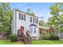 Charming home with a red door, bay window and stairs to the front door entrance at 3474 Kingswood Run, Decatur, GA 30034