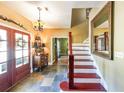 Inviting foyer with tiled floor, wooden staircase, and decorative accents, creating a warm entrance at 12 Blackfoot Trl, Sharpsburg, GA 30277
