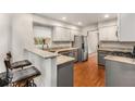 Modern kitchen features granite countertops, stainless steel appliances, and a breakfast bar area at 1341 Sheffield Glen Ne Way, Atlanta, GA 30329