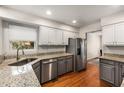 Modern kitchen features stainless steel appliances, granite countertops, and ample cabinet space at 1341 Sheffield Glen Ne Way, Atlanta, GA 30329