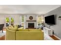 Cozy living room with fireplace, hardwood floors, large windows and lots of natural light at 1341 Sheffield Glen Ne Way, Atlanta, GA 30329
