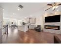 Open-concept living area with fireplace, kitchen island, and dining area with hardwood floors at 3075 Westpoint Cir, Snellville, GA 30078