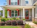 Inviting front porch with white rocking chairs and seasonal floral arrangements at 33 New Kent Ct, Villa Rica, GA 30180