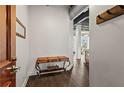Modern entryway featuring wood floors, a decorative table, and neutral walls, leading into the main living space at 3820 Roswell Ne Rd # 1001, Atlanta, GA 30342
