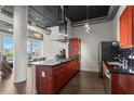 Contemporary kitchen with cherry cabinets, stainless steel appliances, a gas cooktop, and dark countertops at 3820 Roswell Ne Rd # 1001, Atlanta, GA 30342