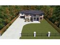 Aerial view of a modern home surrounded by lush greenery and a long driveway at 1349 Oak Road, Lilburn, GA 30047