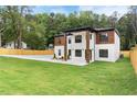 Spacious yard showcasing a modern two-story home with a well-manicured lawn and privacy fence at 1349 Oak Road, Lilburn, GA 30047