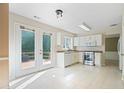White kitchen with stainless steel appliances and access to the deck at 523 Huntgate Rd, Woodstock, GA 30189