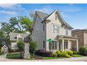 Exterior view of the gray two-story home, showing the well-kept yard, street view, and architectural details at 5981 Brundage Ln, Norcross, GA 30071