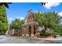 Striking brick building with arched entryways and mature landscaping offers a luxurious living experience at 1850 Cotillion Dr # 3215, Atlanta, GA 30338
