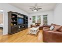 Comfortable living room with hardwood floors, leather seating, ceiling fan, and natural light at 1850 Cotillion Dr # 3215, Atlanta, GA 30338