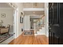 Elegant foyer with hardwood floors and a staircase leading to the upper level at 4045 Bonnett Creek Ln, Hoschton, GA 30548