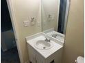 Cozy half bath featuring a vanity with a sink and large mirror at 1165 Oaks Pl, Stone Mountain, GA 30083